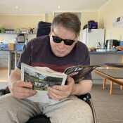 Mr Leigh Warren busy reading his magazine